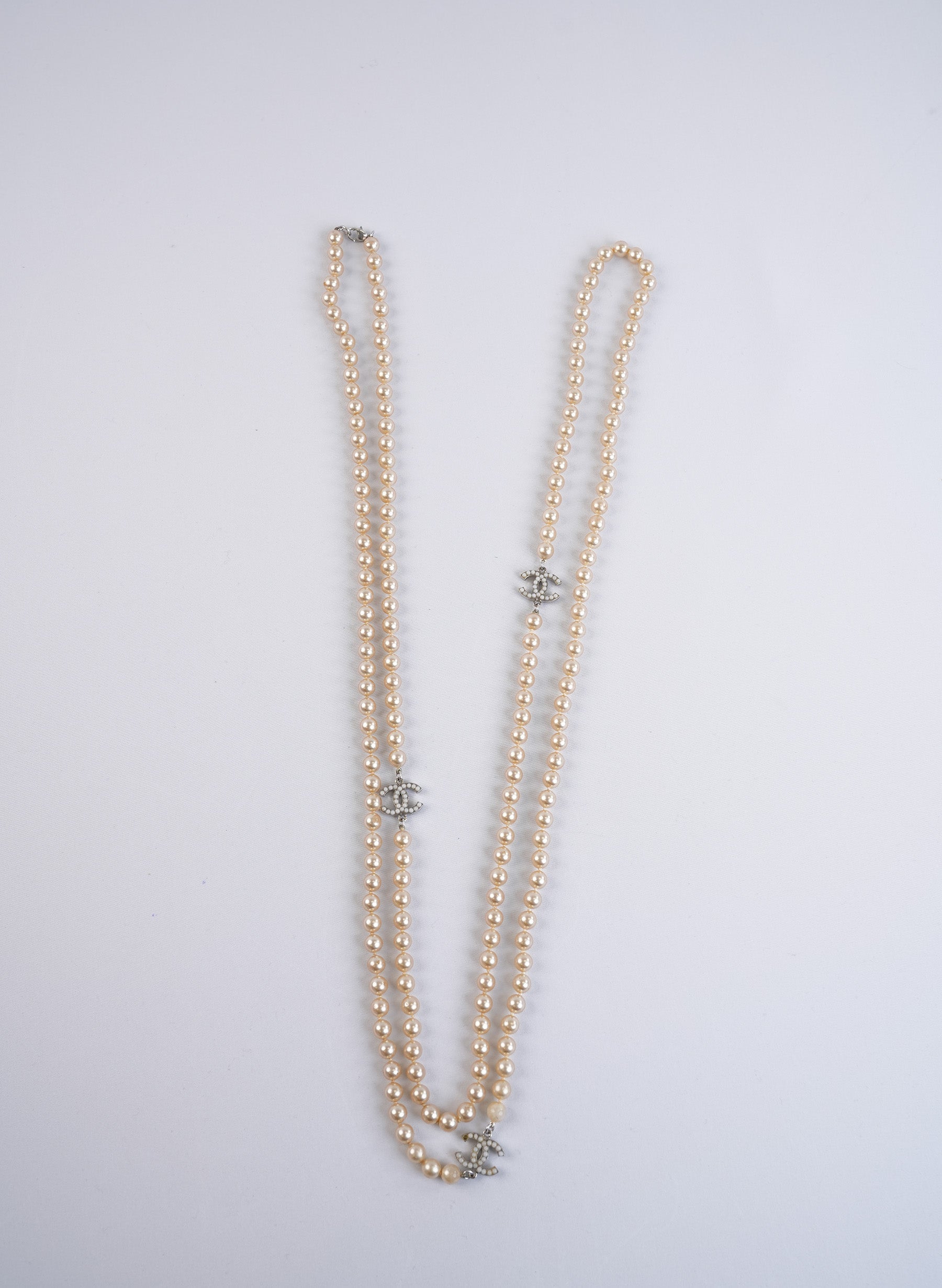 Chanel Long Faux Pearl Necklace With CC Logo Charms